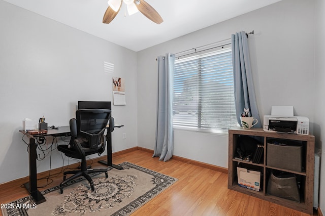 home office with baseboards, light wood finished floors, and ceiling fan