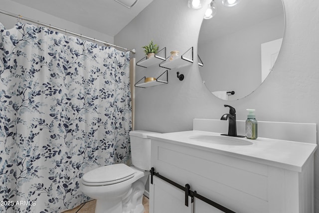 bathroom with tile patterned floors, toilet, vanity, and a shower with curtain