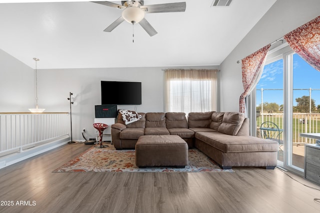 living area featuring a ceiling fan, lofted ceiling, wood finished floors, and visible vents