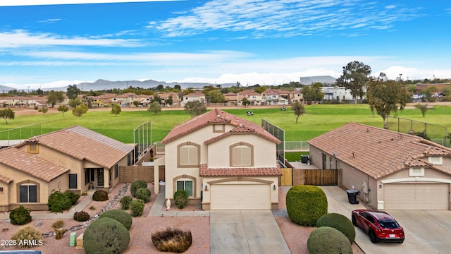 view of front facade with fence, driveway, and stucco siding