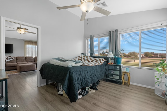 bedroom featuring multiple windows, wood finished floors, and visible vents