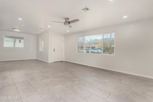 empty room with visible vents, recessed lighting, baseboards, and ceiling fan