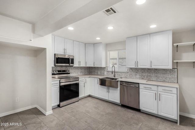 kitchen featuring visible vents, backsplash, appliances with stainless steel finishes, and open shelves