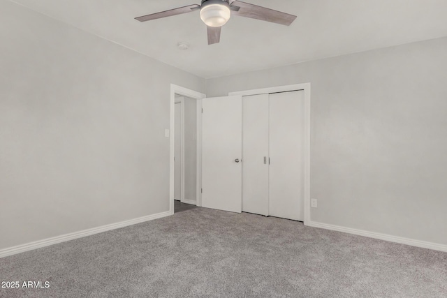 unfurnished bedroom featuring carpet flooring, baseboards, a closet, and ceiling fan