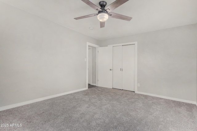 unfurnished bedroom featuring baseboards, carpet floors, a closet, and a ceiling fan