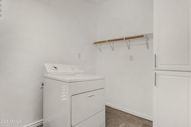 clothes washing area featuring baseboards, washer / dryer, and laundry area