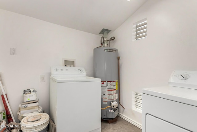 washroom with laundry area, gas water heater, and washer and dryer