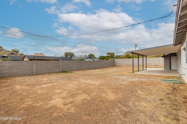 view of yard featuring a patio area and a fenced backyard