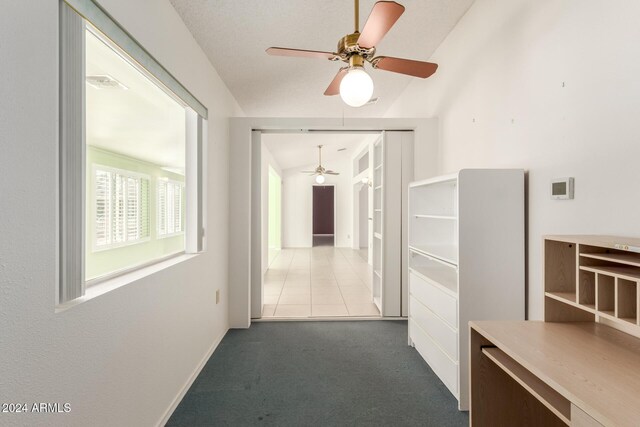 corridor with carpet floors and vaulted ceiling