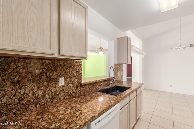 kitchen with dishwasher, sink, dark stone counters, and tasteful backsplash