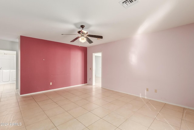 tiled empty room with ceiling fan