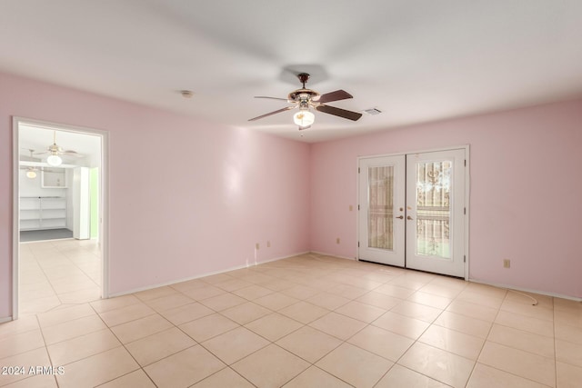 empty room with ceiling fan, french doors, and light tile patterned flooring