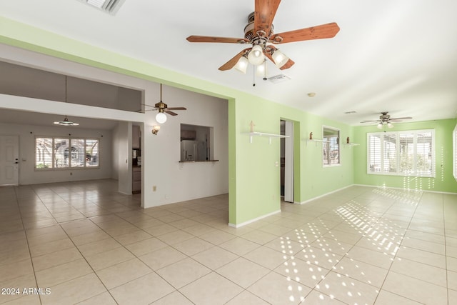 unfurnished room featuring light tile patterned floors and ceiling fan