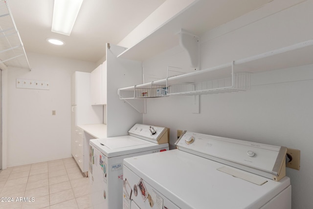 laundry area featuring light tile patterned floors and washer and clothes dryer