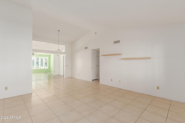 unfurnished room featuring ceiling fan, light tile patterned flooring, and high vaulted ceiling