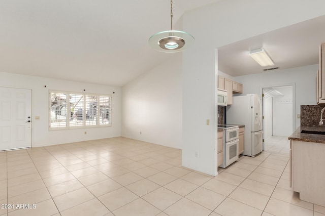 kitchen with light brown cabinets, white appliances, lofted ceiling, and light tile patterned flooring