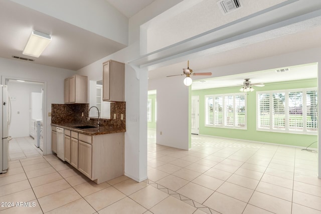 kitchen featuring light brown cabinets, white appliances, sink, light tile patterned floors, and tasteful backsplash