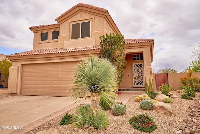 mediterranean / spanish house featuring stucco siding, fence, a garage, driveway, and a tiled roof