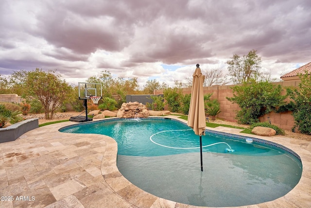 view of swimming pool with a fenced in pool, a fenced backyard, and a patio