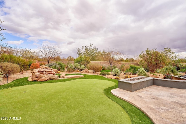 view of yard with fence and a patio