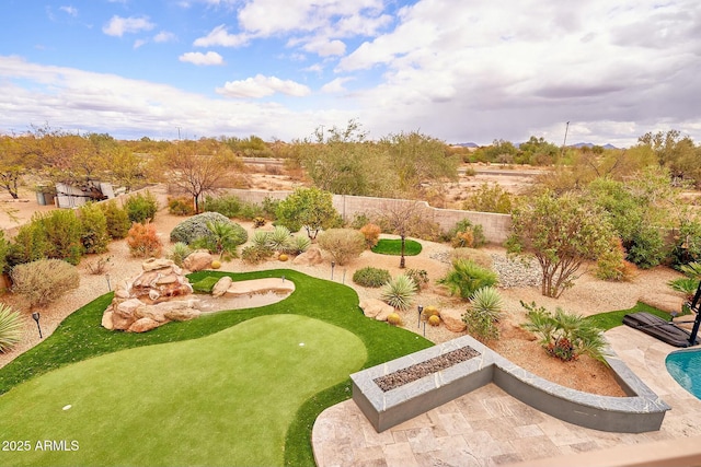 view of yard featuring a patio area, fence, and a fire pit