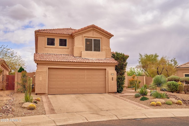 mediterranean / spanish home with a garage, fence, concrete driveway, a tiled roof, and stucco siding