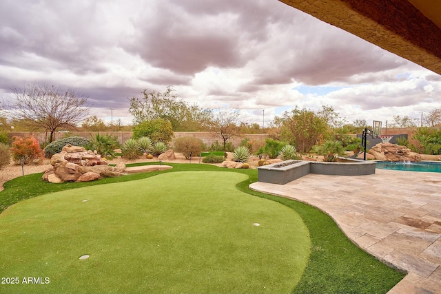 view of community with a fenced backyard and a patio