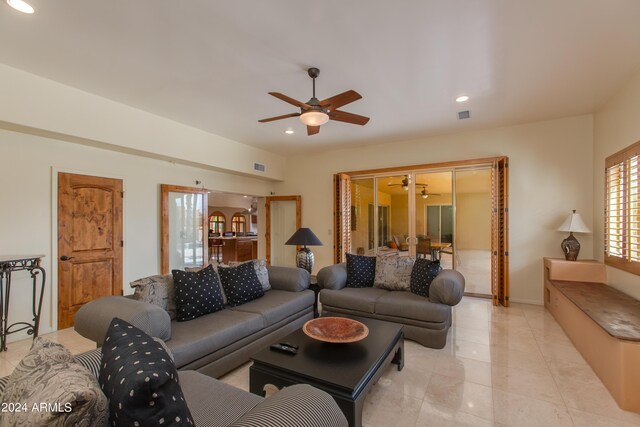 sitting room with wood-type flooring, sink, ceiling fan, and a skylight