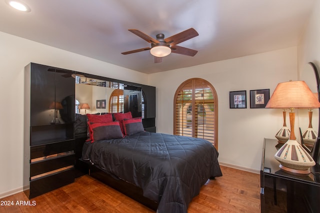 bedroom featuring light hardwood / wood-style floors and ceiling fan