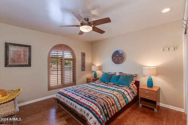 bedroom featuring dark wood finished floors, a ceiling fan, and baseboards