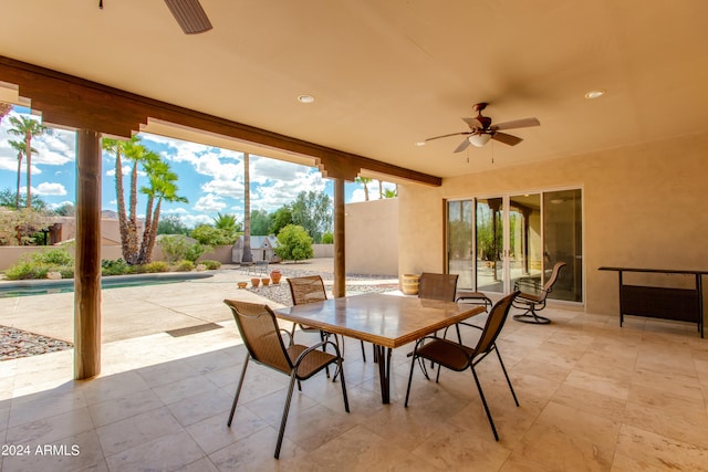 view of patio featuring a fenced in pool, outdoor dining area, and ceiling fan