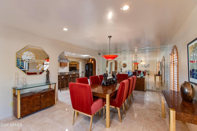 dining area with arched walkways and recessed lighting