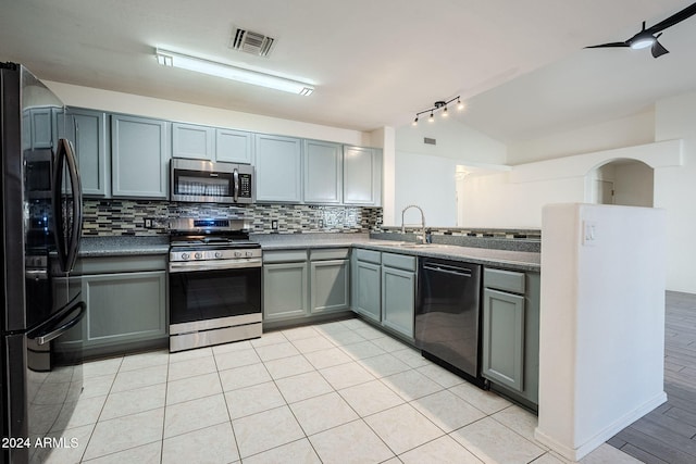 kitchen featuring black appliances, sink, tasteful backsplash, and lofted ceiling