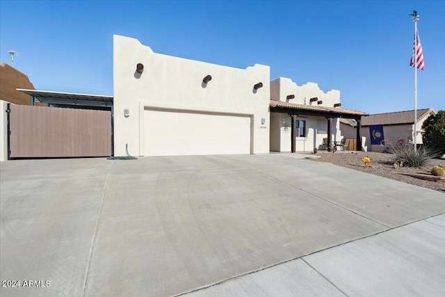 pueblo-style home featuring a garage