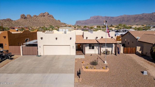 view of front of home with a garage and a mountain view