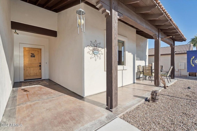 property entrance featuring a patio area