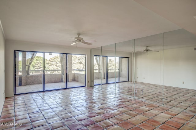 spare room with tile patterned floors and a ceiling fan