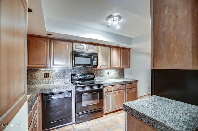 kitchen featuring tile countertops, light tile patterned floors, black appliances, a raised ceiling, and tasteful backsplash