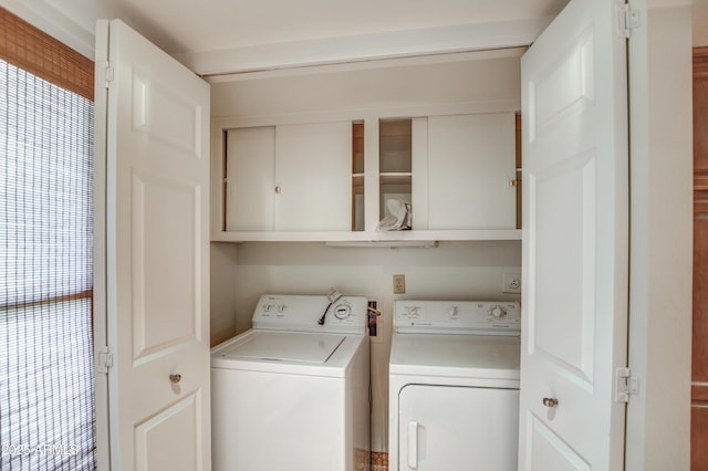 laundry room featuring washer and clothes dryer and cabinet space