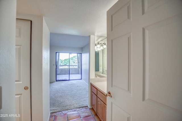 bathroom featuring vanity, tile patterned flooring, and a textured ceiling