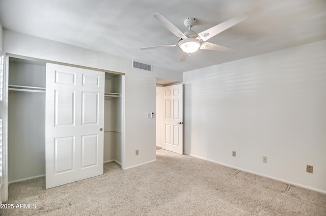 unfurnished bedroom featuring visible vents, baseboards, carpet flooring, a closet, and a ceiling fan