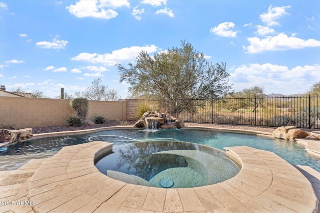 view of pool with an in ground hot tub and pool water feature