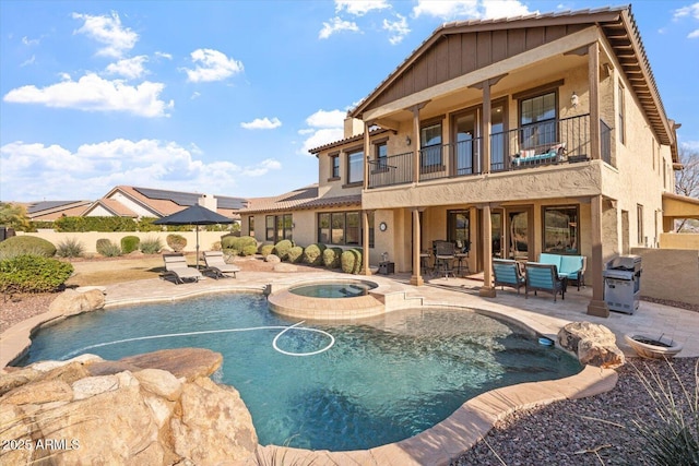 view of pool with an in ground hot tub, an outdoor living space, a patio, and area for grilling