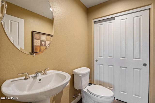 bathroom with toilet and sink