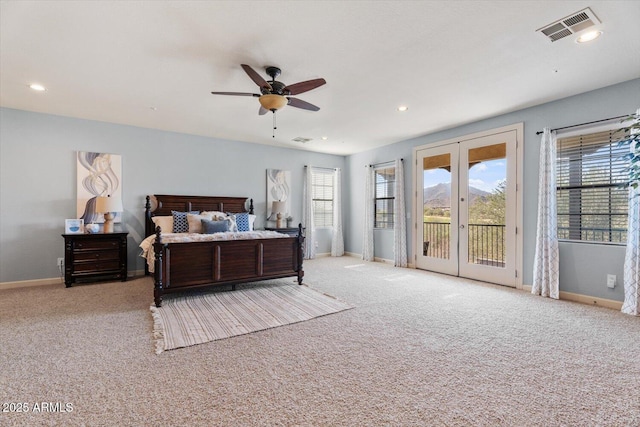 bedroom with access to exterior, french doors, multiple windows, and ceiling fan