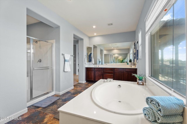 bathroom with vanity and independent shower and bath