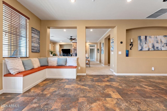 unfurnished living room featuring ceiling fan and ornamental molding