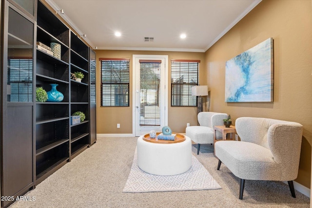 living area with carpet and crown molding