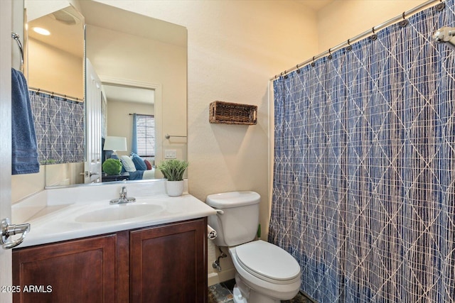 bathroom featuring vanity and toilet