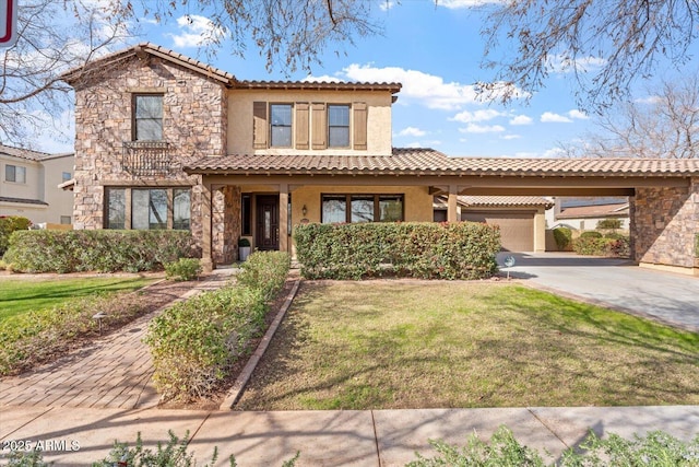 mediterranean / spanish-style house with a carport, a garage, and a front yard